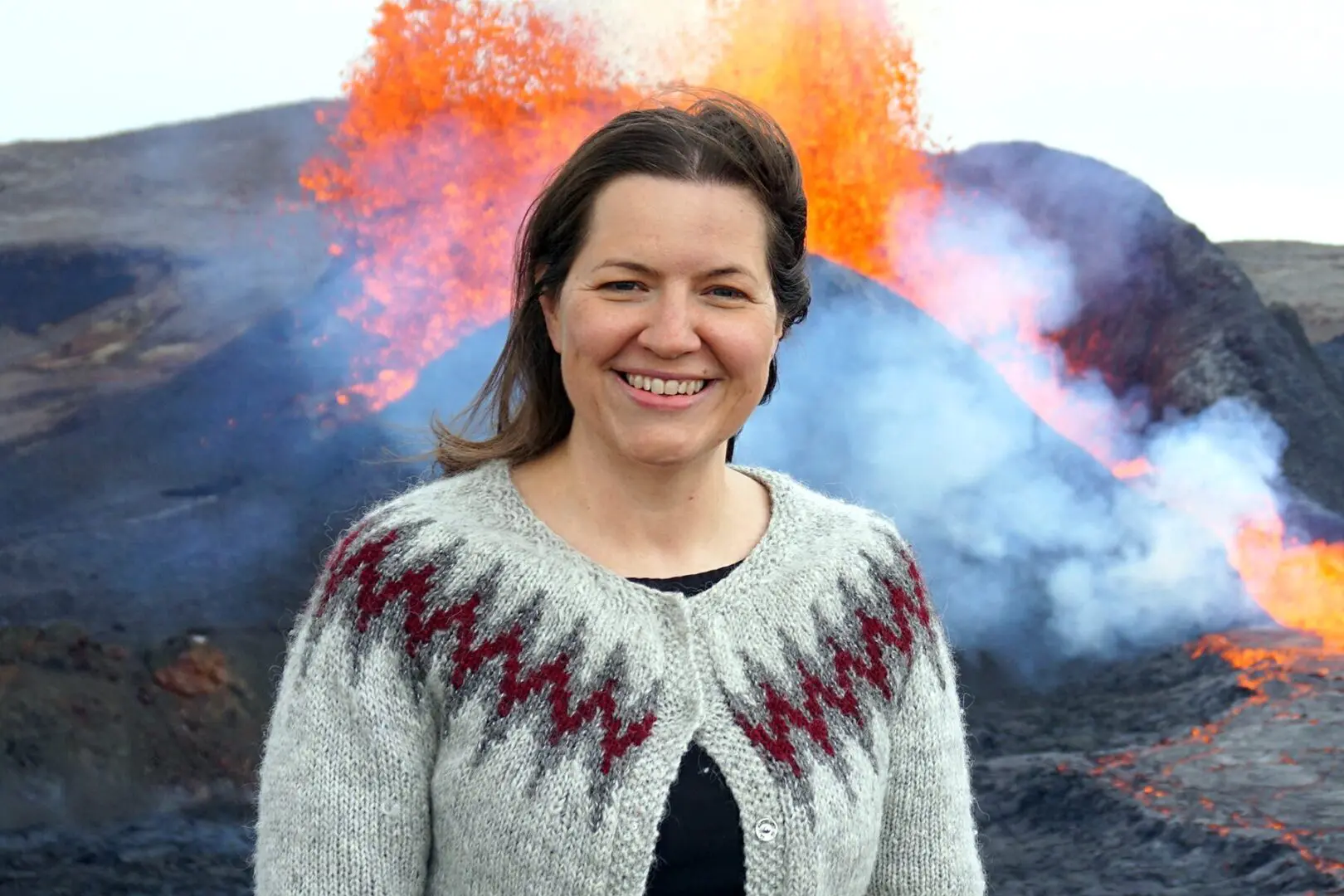 First Lady Eliza Reid stands in front of a volcano in Iceland