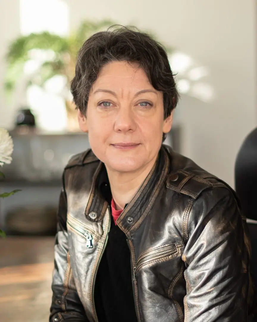 Woman in brown leather jacket portrait.