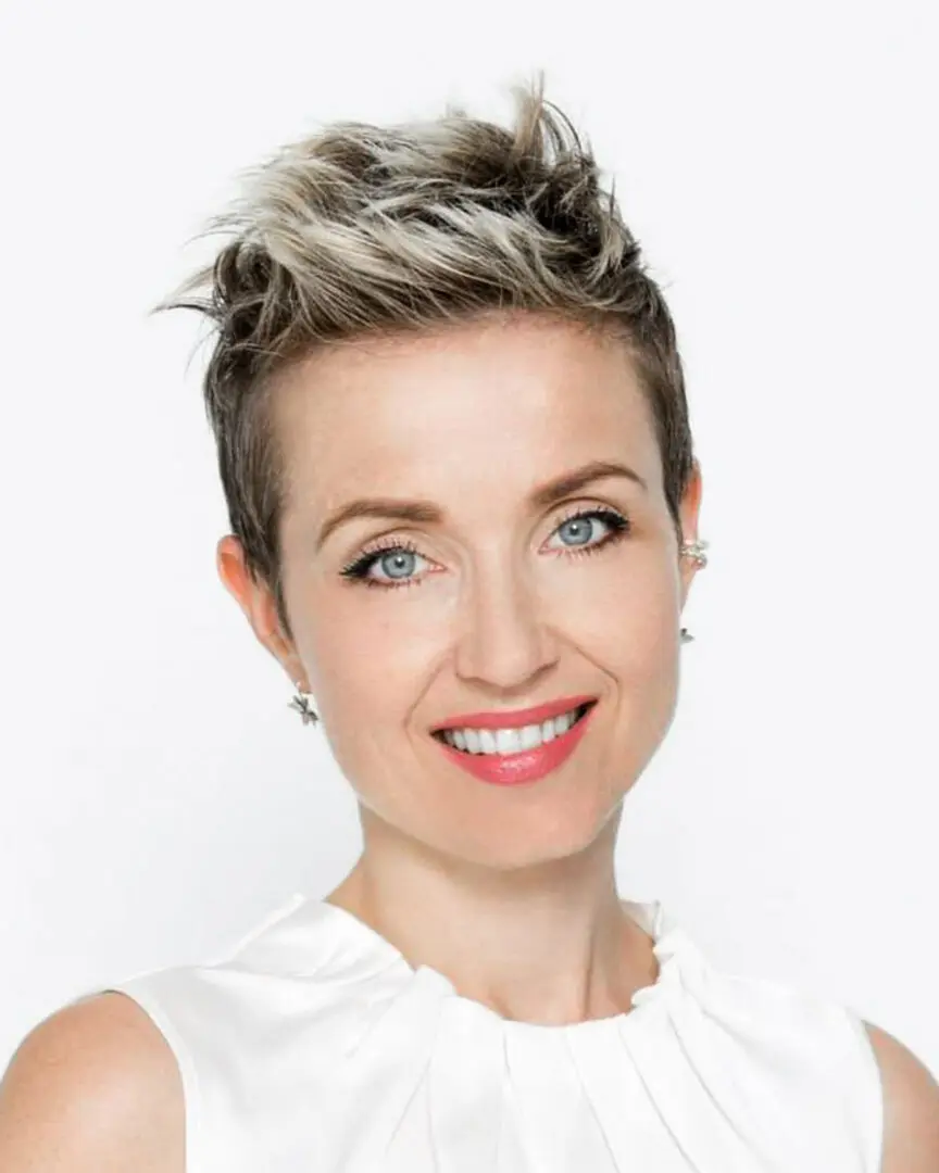 Smiling woman with short, blonde hair.